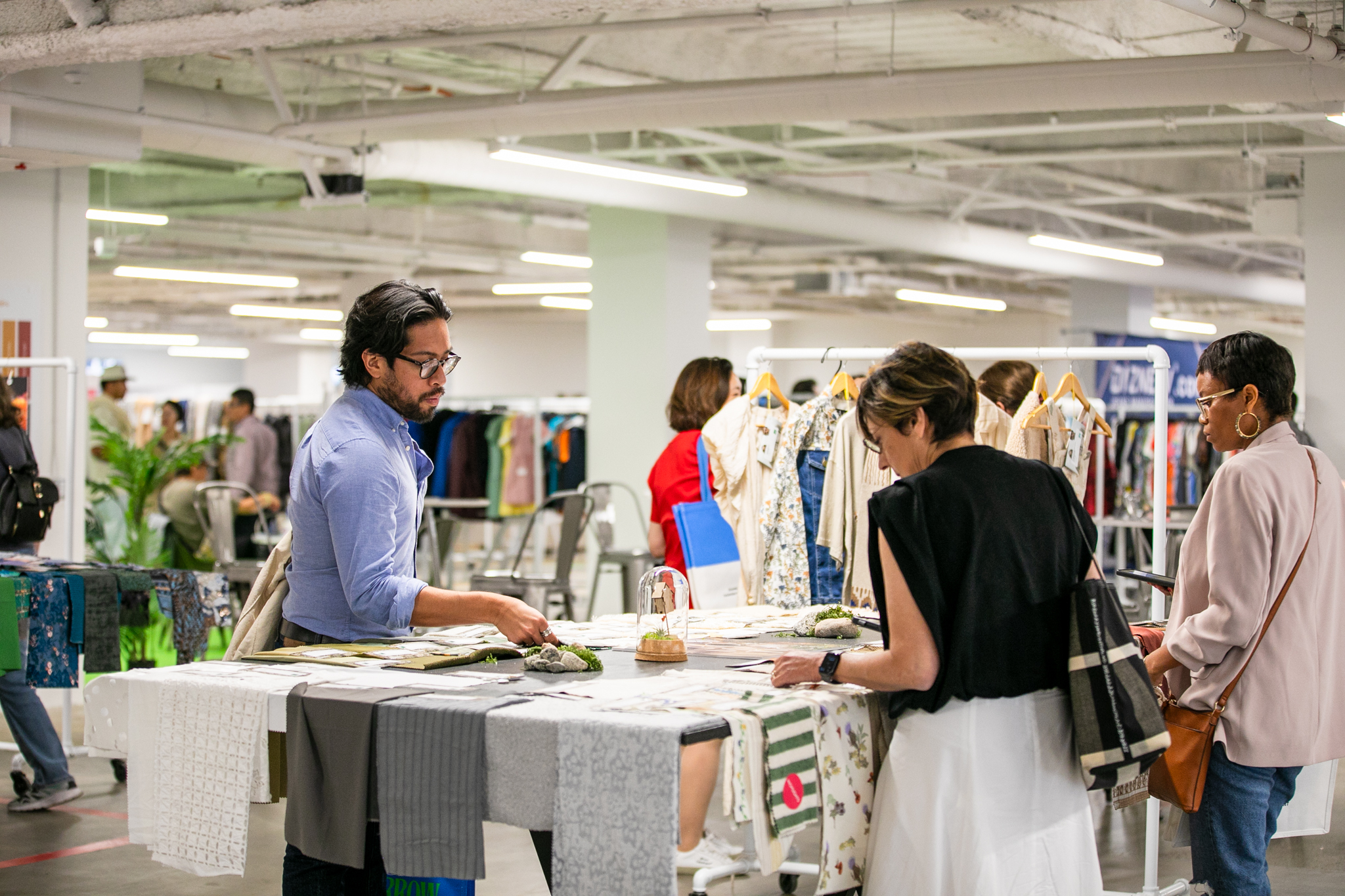 Buyers browsing through sustainable fabric samples at Texworld Los Angeles